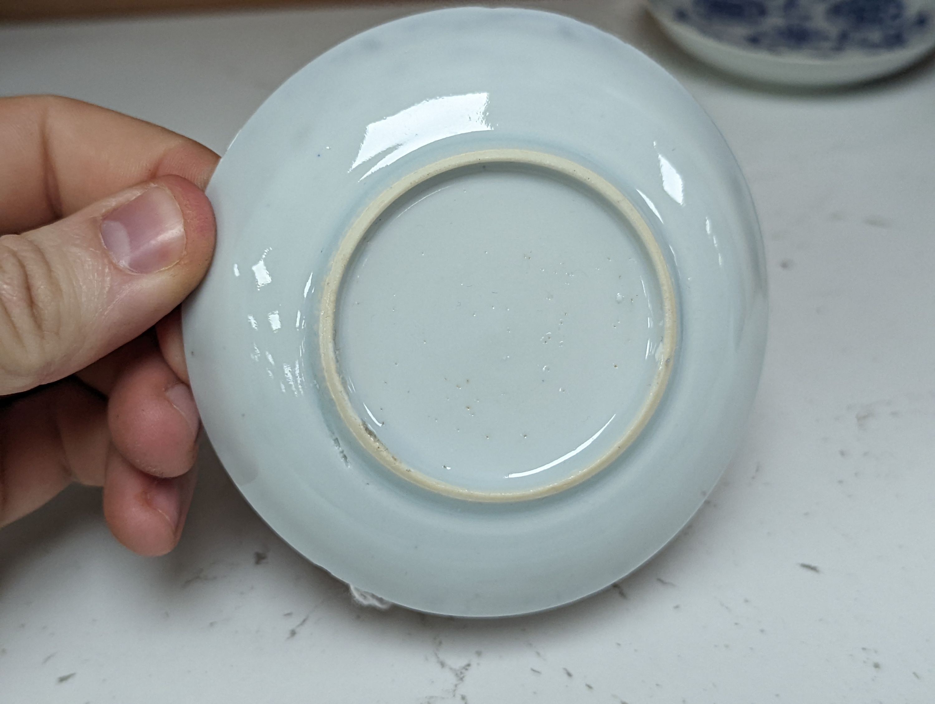 Seven 18th century Chinese saucer dishes, largest 14 cms diameter.